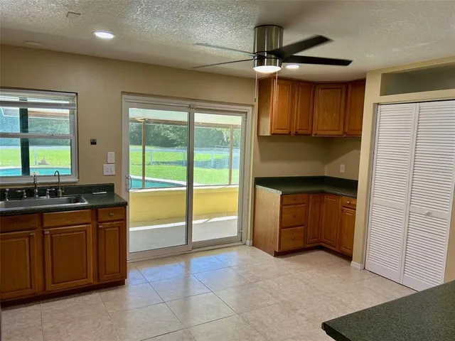 a kitchen with stainless steel appliances granite countertop a stove and a refrigerator