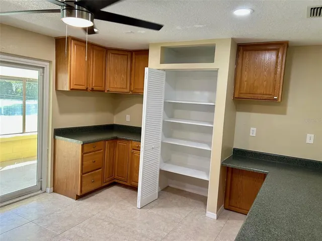 a kitchen with granite countertop cabinets and window