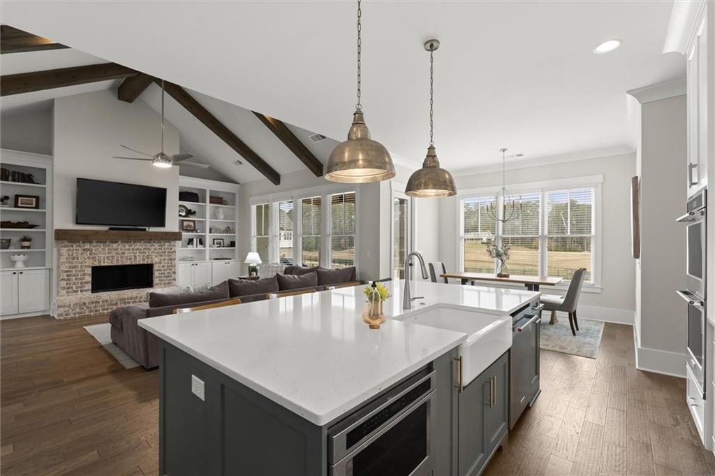 3809 Cochran Lake Road Marietta, GA 30062 - Photo 12 of 40 a kitchen with a stove center island a counter space a sink and living room view