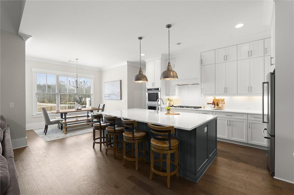 3809 Cochran Lake Road Marietta, GA 30062 - Photo 16 of 40 a open kitchen with stainless steel appliances granite countertop a sink and white cabinets next to a large window
