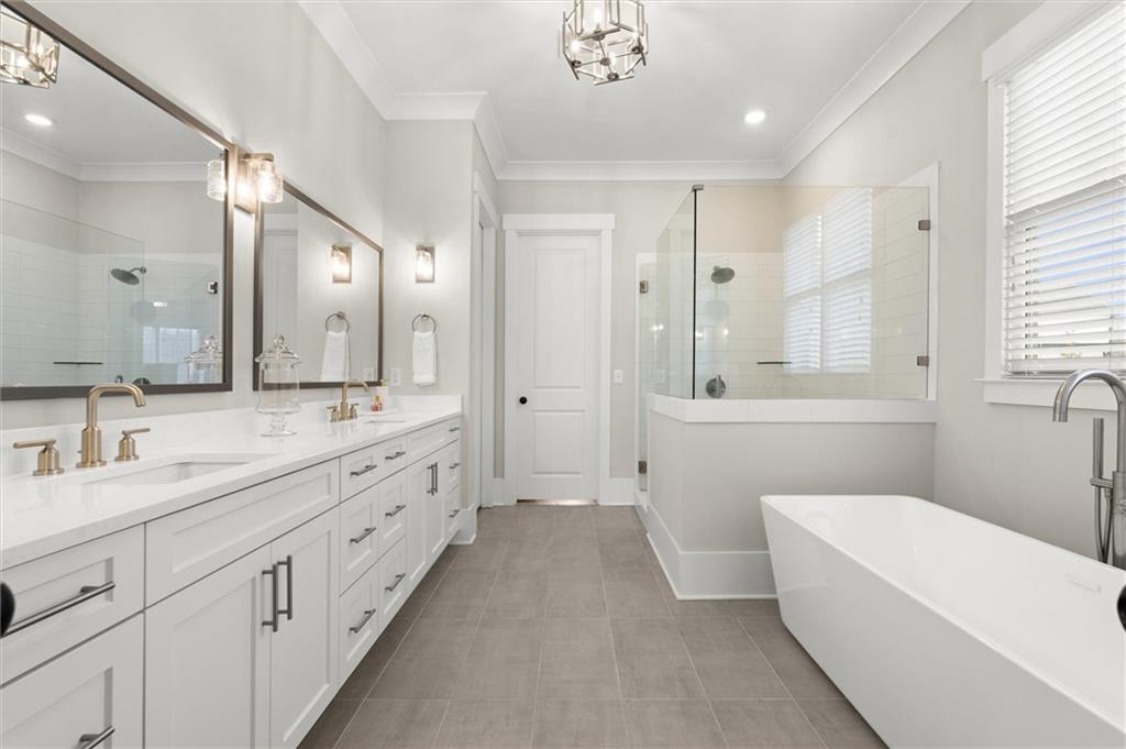 3809 Cochran Lake Road Marietta, GA 30062 - Photo 24 of 40 a spacious bathroom with double vanity a toilet a a mirror a bathtub and shower