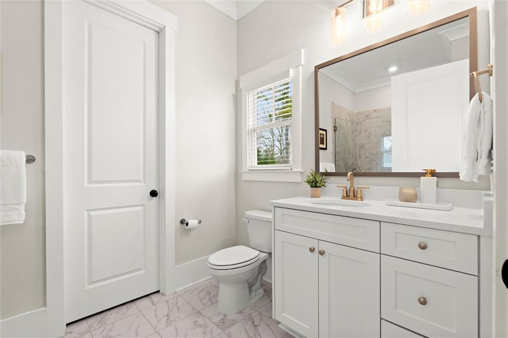 3809 Cochran Lake Road Marietta, GA 30062 - Photo 28 of 40 a bathroom with a toilet sink and mirror