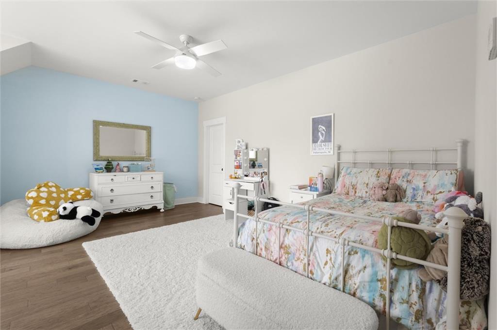 3809 Cochran Lake Road Marietta, GA 30062 - Photo 32 of 40 a bedroom with a bed and a chandelier