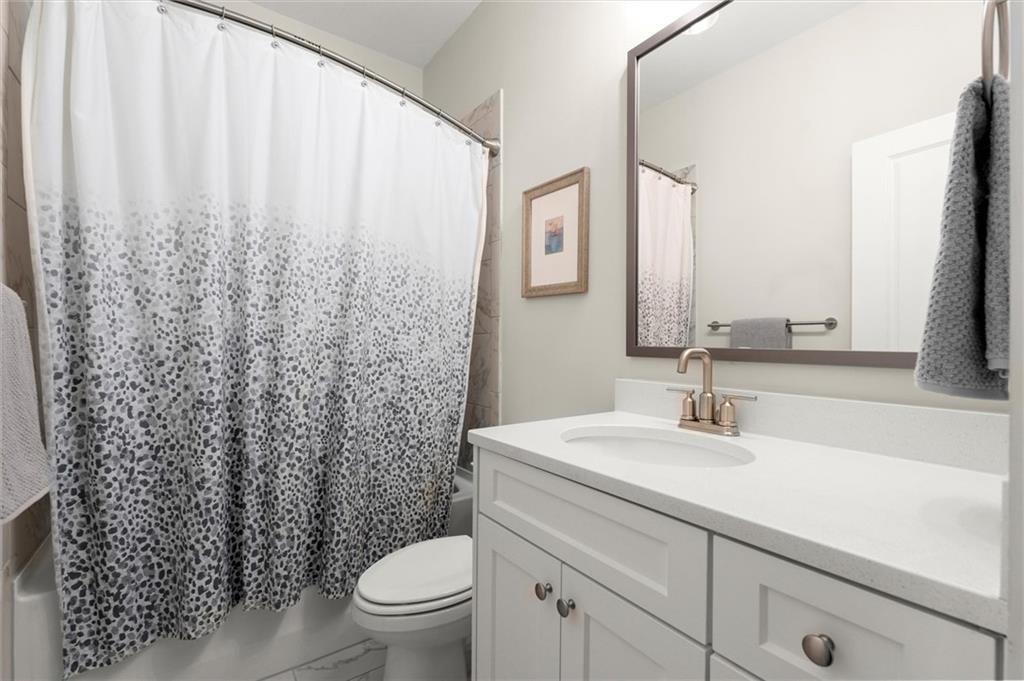 3809 Cochran Lake Road Marietta, GA 30062 - Photo 33 of 40 a bathroom with a sink a toilet and a mirror