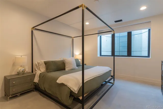 a bedroom with a bed and window