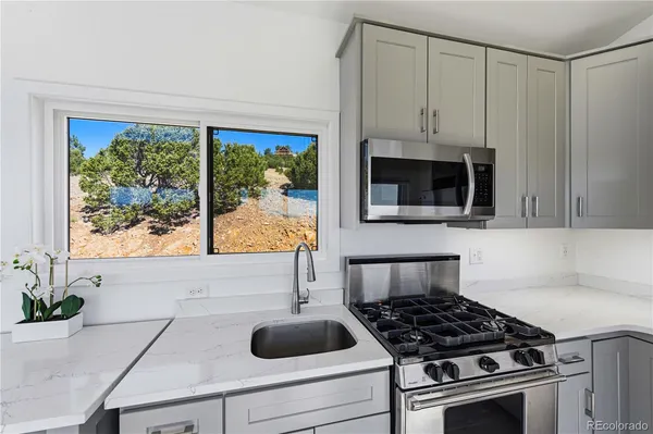 a kitchen with a stove and a window