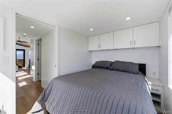 a bedroom with a bed and cabinets