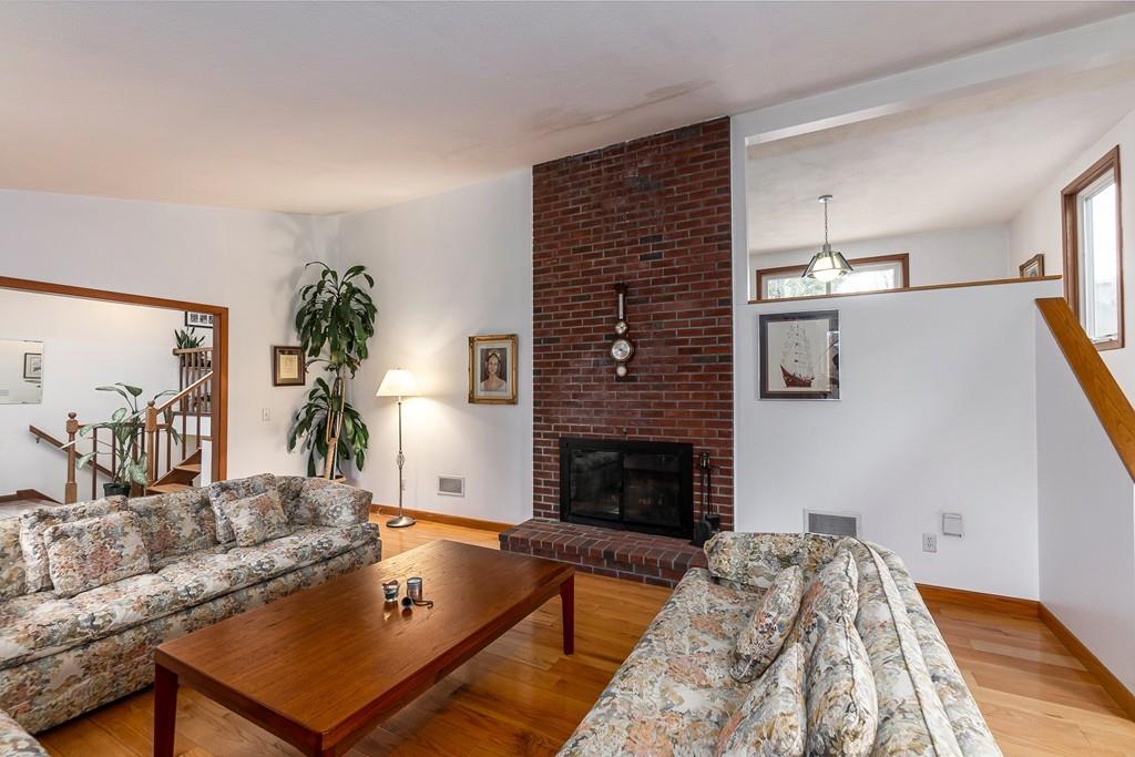 2 Ryder Lane Lexington, MA 02421 - Photo 4 of 14 a living room with furniture flat screen tv and a fireplace