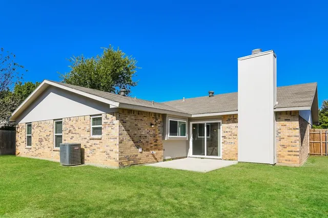 a view of a house with a yard and garden