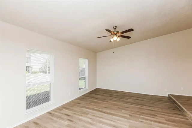 wooden floor in an empty room with a window
