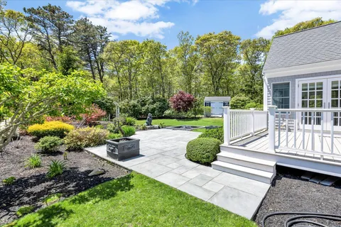 a view of a porch with furniture and a garden