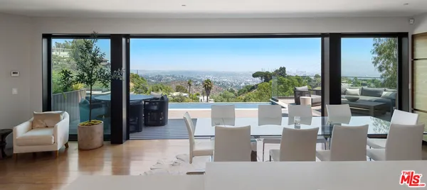 a living room with couches floor and a large window
