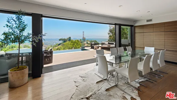 a dining room with furniture and wooden floor