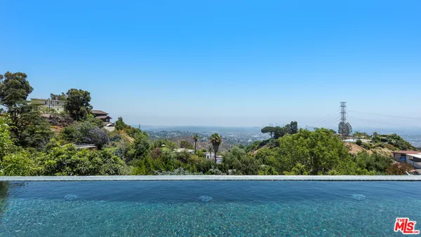 a view of a field with a tree in the background
