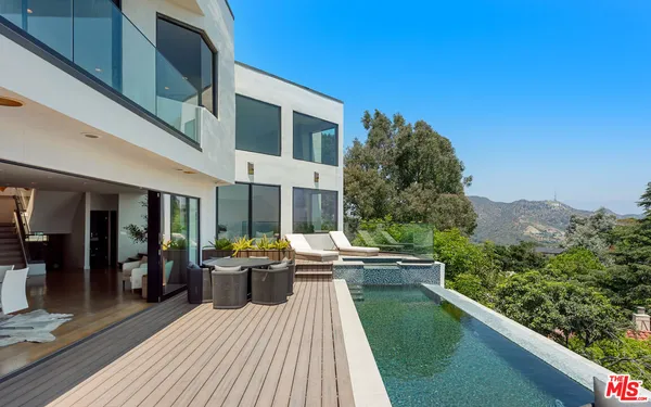 a view of a house with backyard sitting area and garden