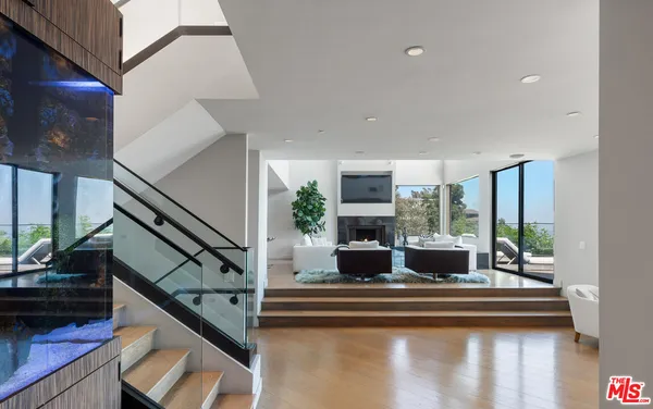 a view of living room with furniture and large windows