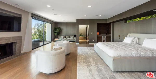 a spacious bedroom with a large bed and a large window