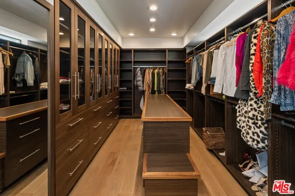 a bathroom with a granite countertop bathtub shower sink mirror and toilet