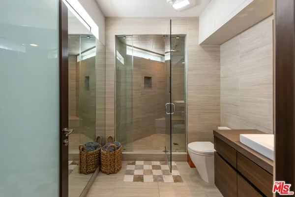 a bathroom with a granite countertop sink mirror and shower