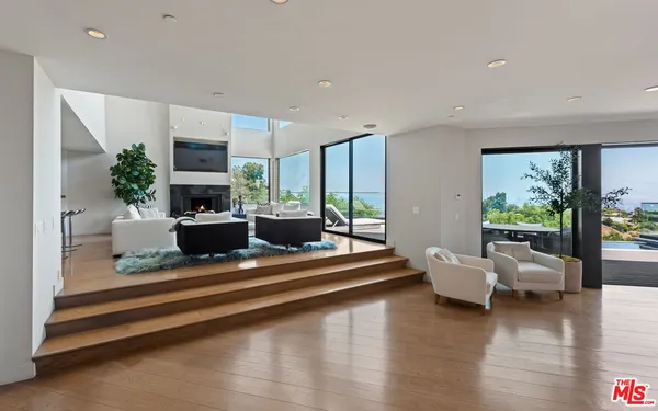 a living room with furniture large window and a flat screen tv