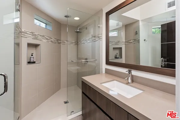 a bedroom with two beds and a television