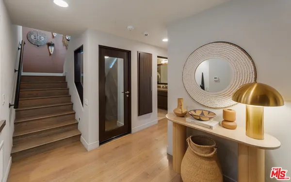 a bedroom with a bed mirror and window