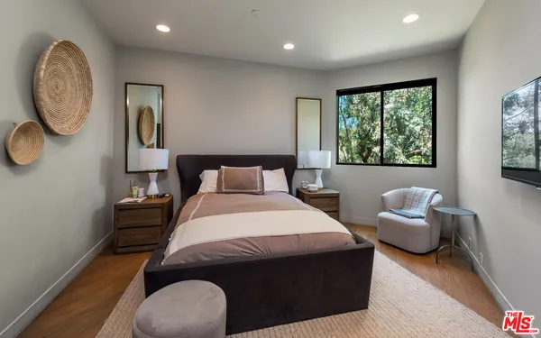 a bedroom with a bed and a mirror