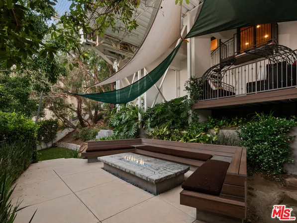 a living room with furniture a fireplace and a floor to ceiling window