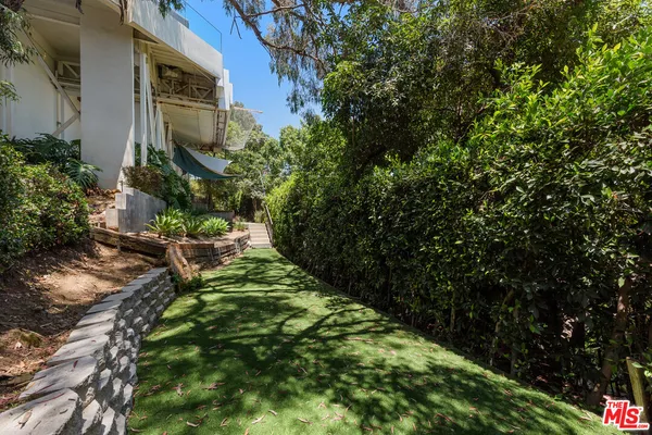 a dining room with furniture a rug and a large mirror