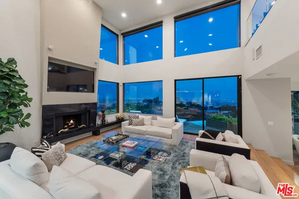 a view of a backyard with plants and outdoor seating