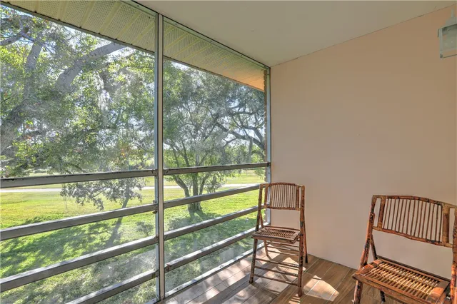 a view of two chairs in the balcony