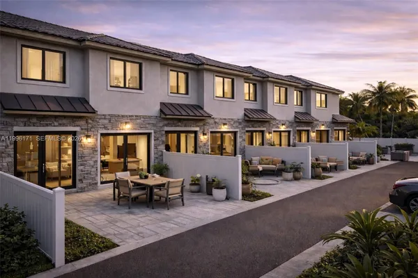 a view of a patio with couches and potted plants