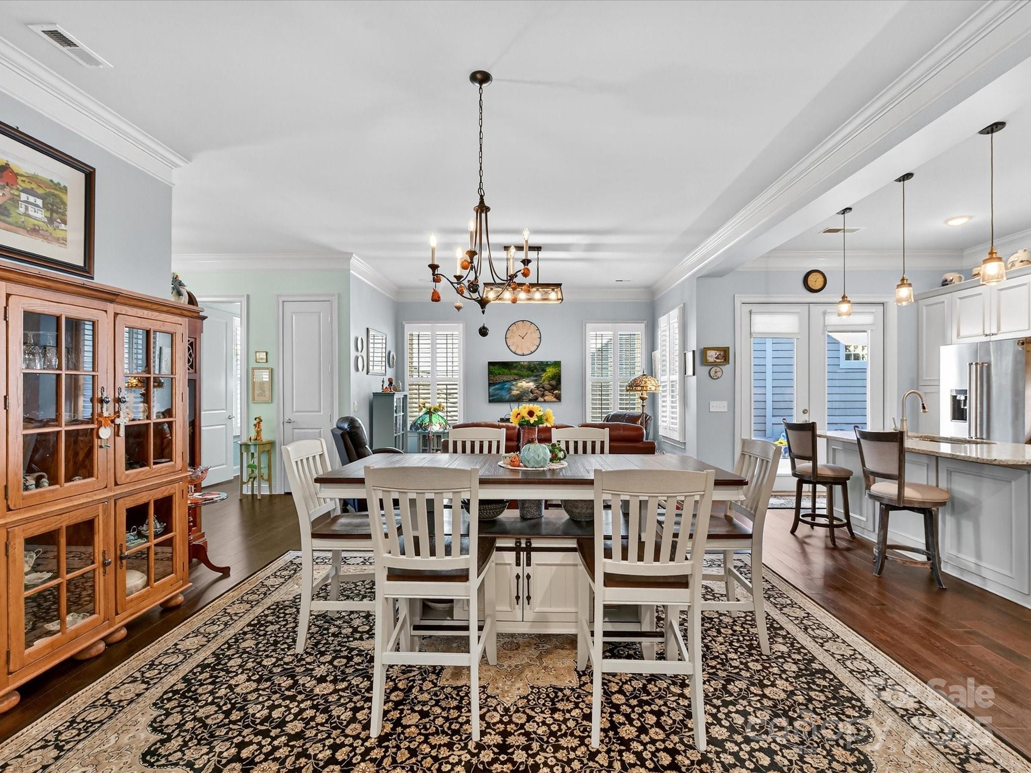 2006 Laney Pond Road Matthews, NC 28104 - Photo 13 of 30 a view of a dining room with furniture wooden floor and chandelier