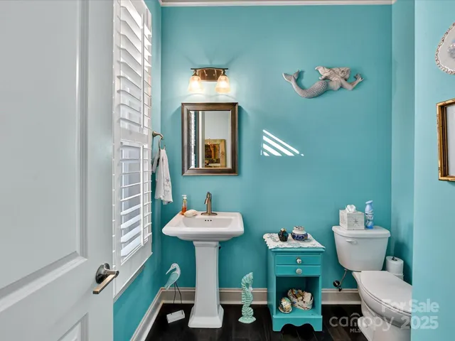 a bathroom with a sink mirror and toilet