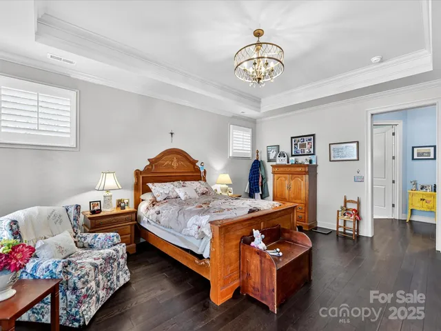 a bedroom with bed and wooden floor