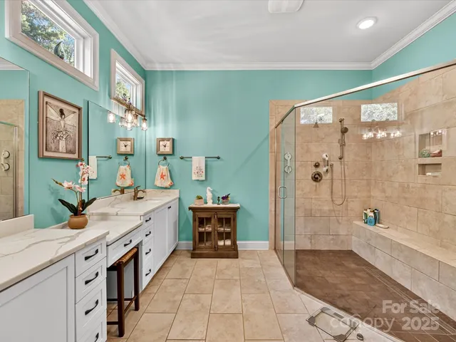 a spacious bathroom with double vanity and a shower