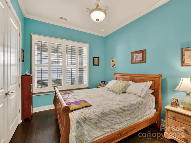 a bed sitting in a bedroom next to a window