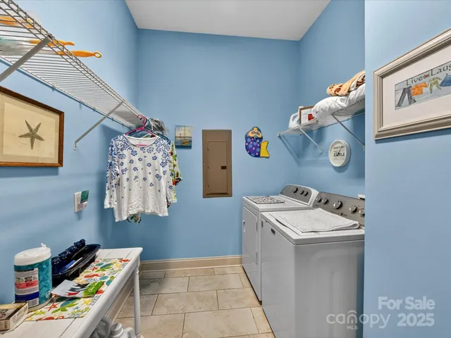 a utility room with fridge and washer