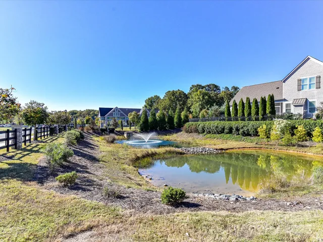 a view of a lake with a house swimming pool and outdoor space