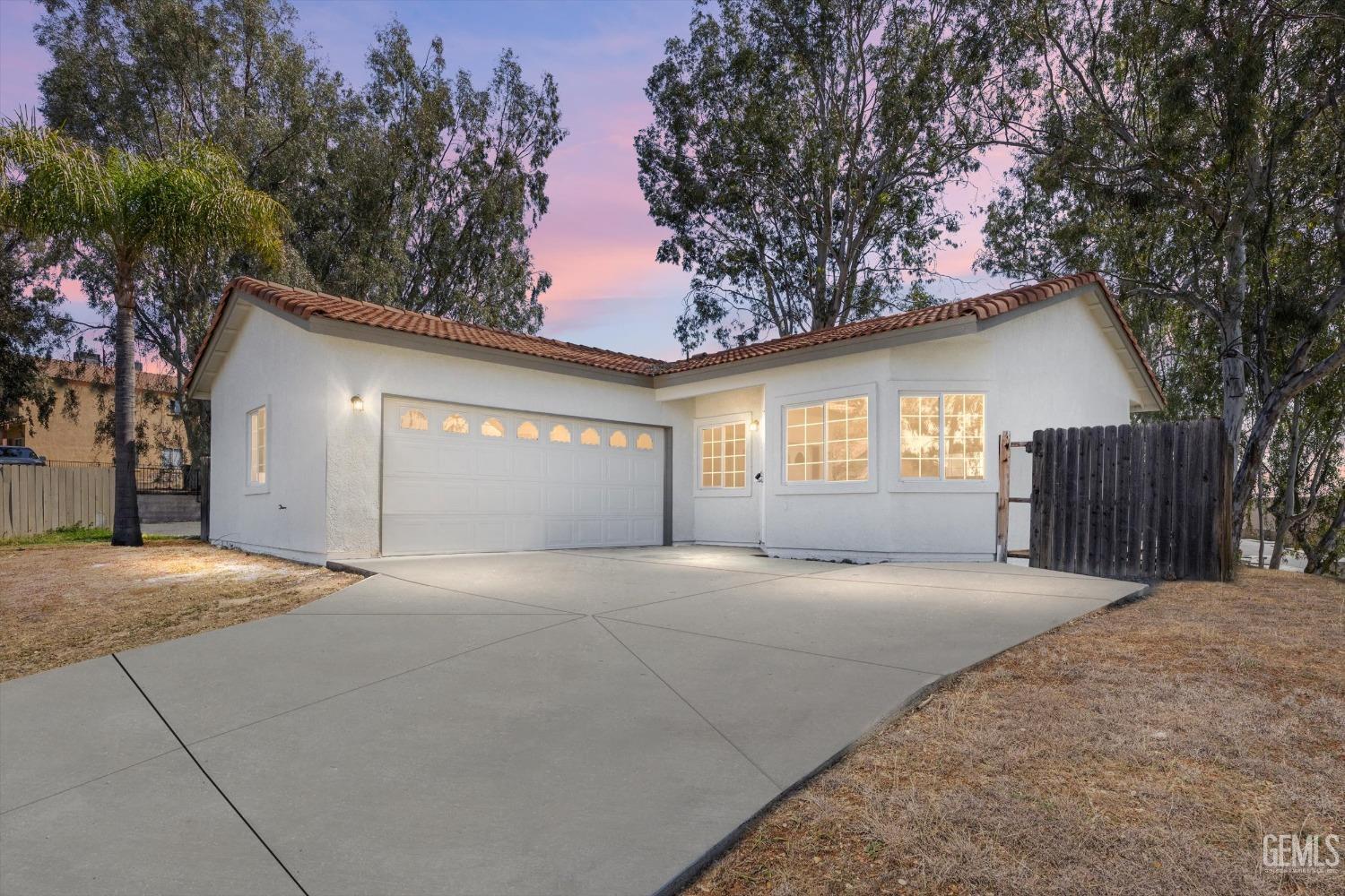 a view of large house with a large tree and windows