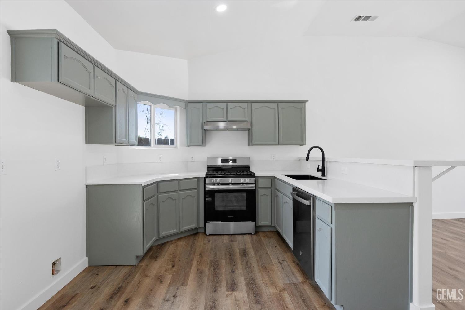 Undisclosed Address Bakersfield, CA 93306 - Photo 12 of 32 a kitchen with a sink a stove and cabinets