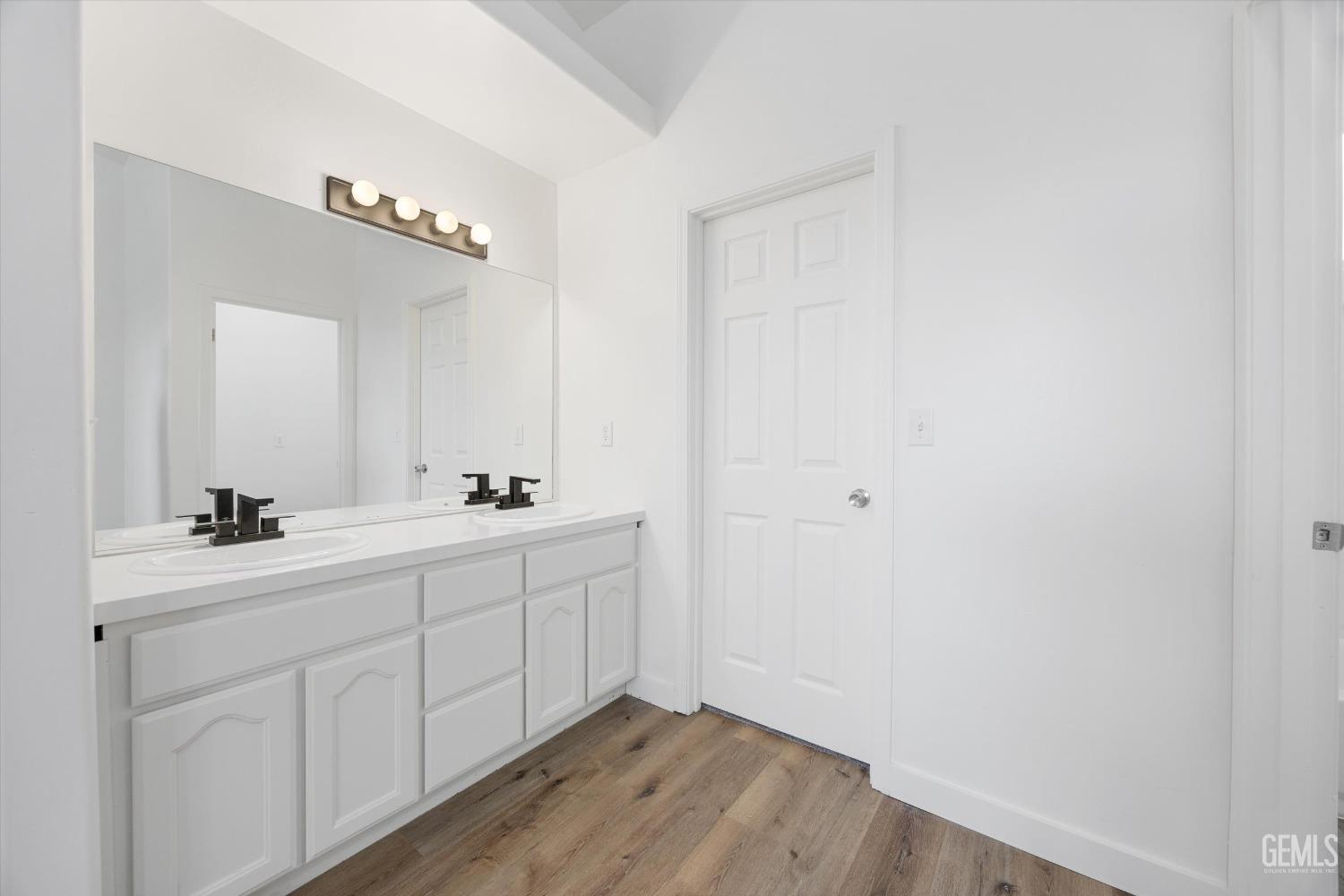 Undisclosed Address Bakersfield, CA 93306 - Photo 19 of 32 a bathroom with a double vanity sink and mirror