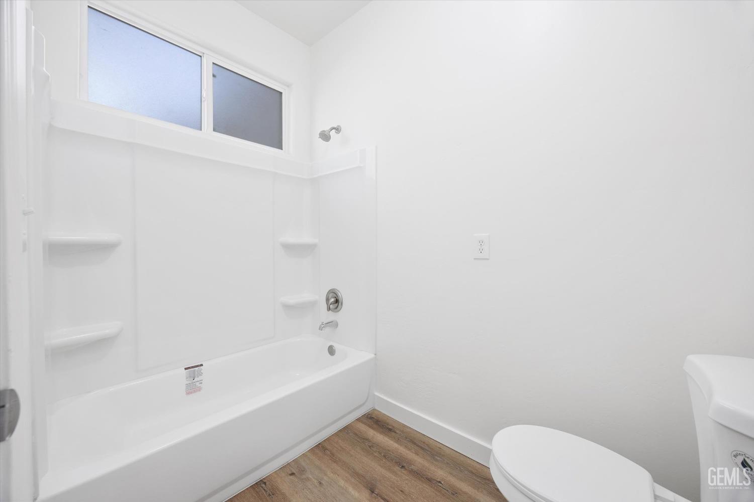 Undisclosed Address Bakersfield, CA 93306 - Photo 20 of 32 a bathroom with a toilet and a bathtub