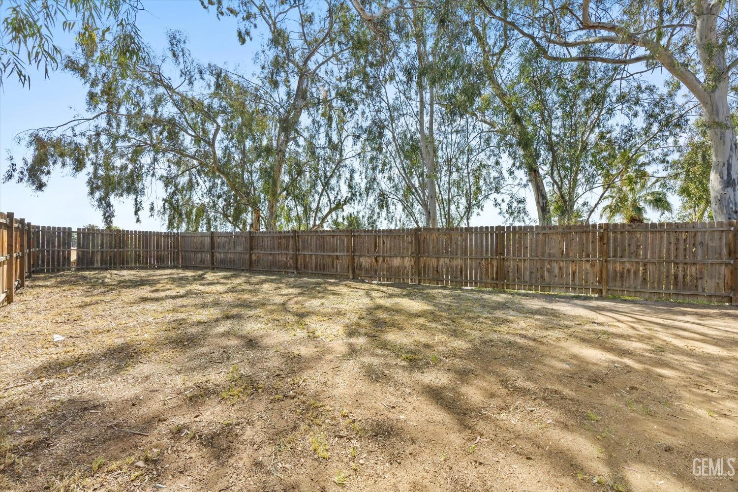 Undisclosed Address Bakersfield, CA 93306 - Photo 30 of 32 a view of a backyard with wooden fence