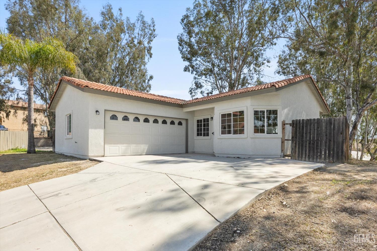 Undisclosed Address Bakersfield, CA 93306 - Photo 3 of 32 a view of garage with a house