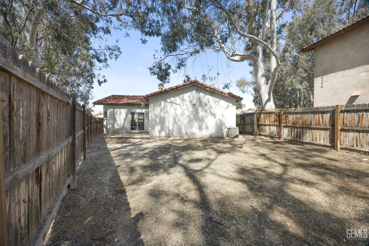 Undisclosed Address Bakersfield, CA 93306 - Photo 32 of 32 a view of a yard with wooden fence