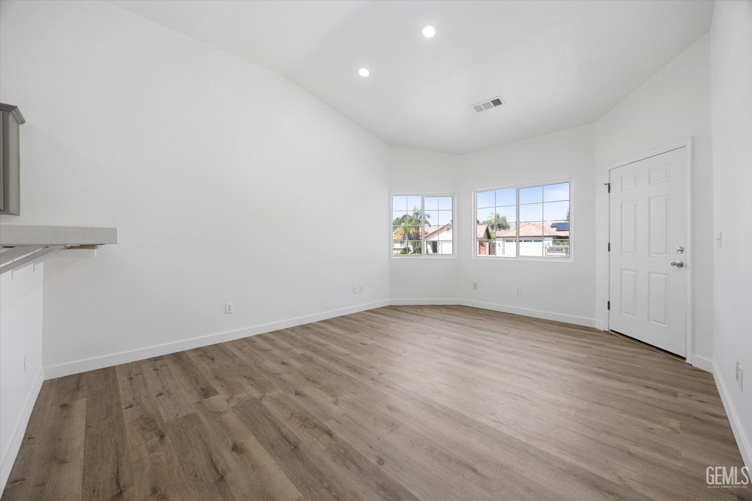 Undisclosed Address Bakersfield, CA 93306 - Photo 8 of 32 a view of a room with wooden floors and window