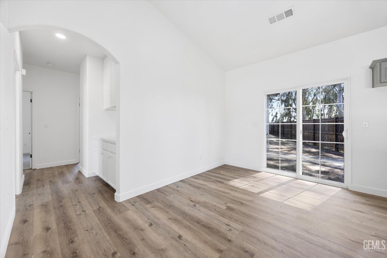 Undisclosed Address Bakersfield, CA 93306 - Photo 10 of 32 an empty room with wooden floor and windows