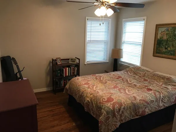 a bed sitting in a bedroom next to a window