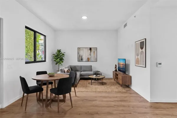 a dining room with furniture and window